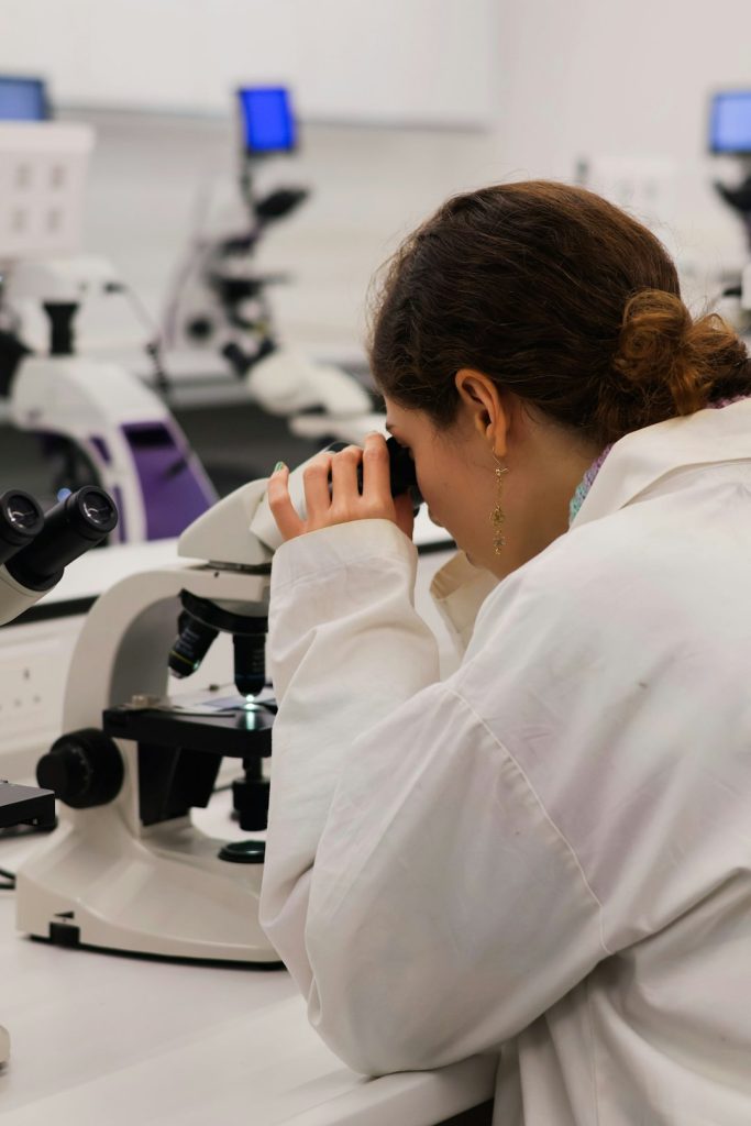scientist-looking-through-a-microscope-in-a-lab-mo1eipp0ah8